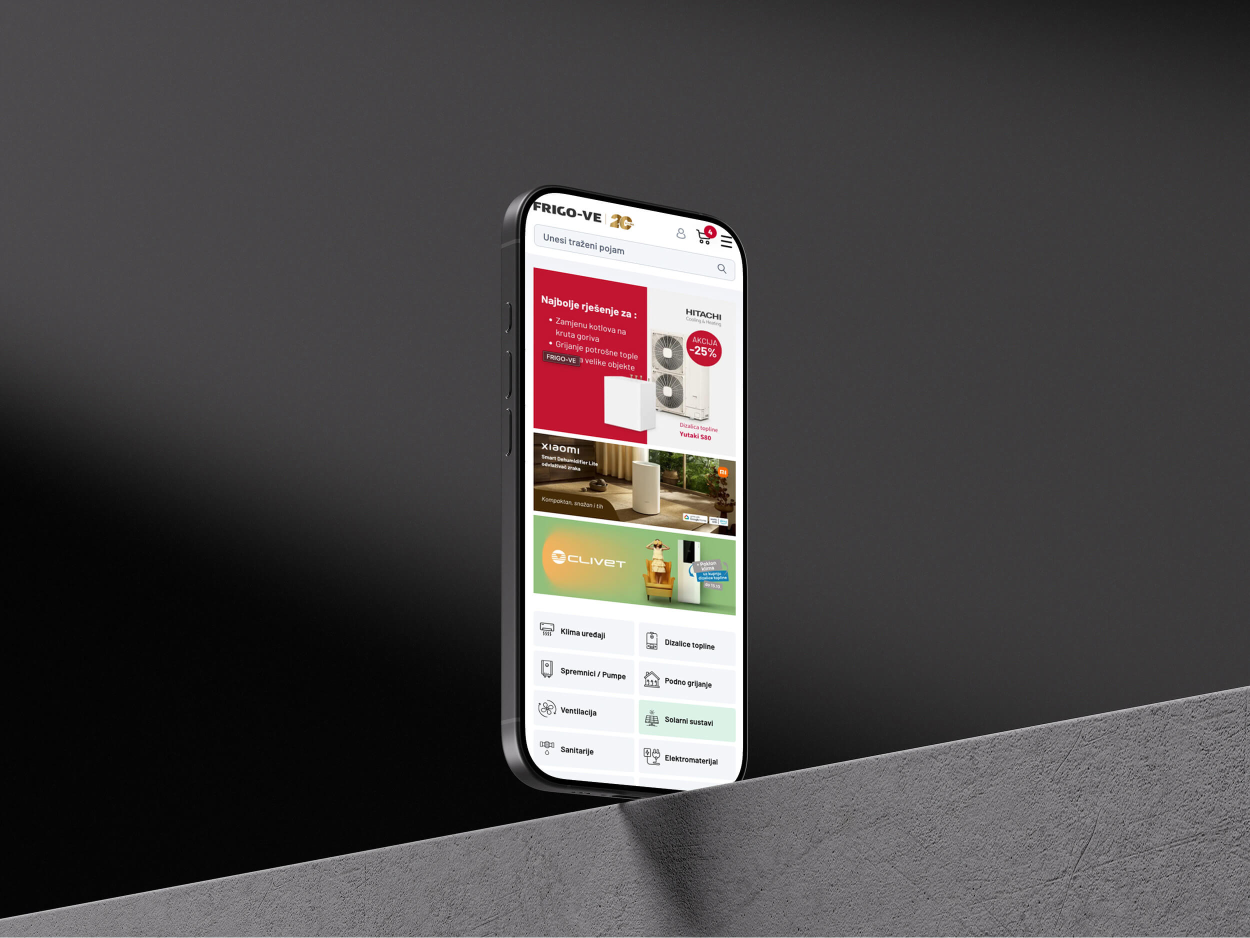 A smartphone leaning against a dark surface, displaying a colorful app interface with images.
